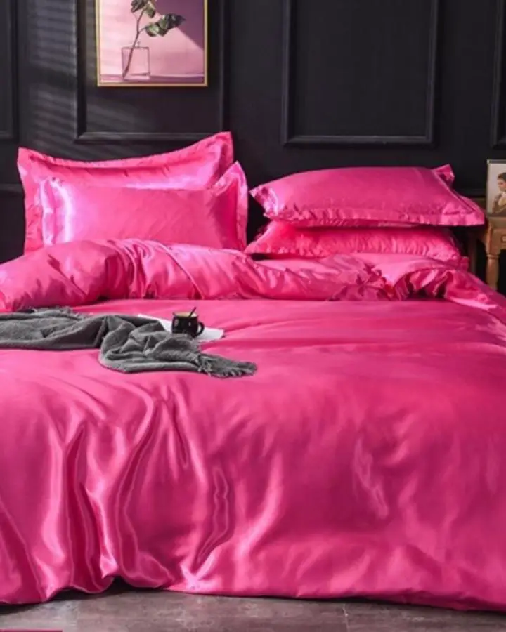 Hot pink silk bedding from The Other Aesthetic showcasing Y2K bedroom decor ideas with glossy finish.