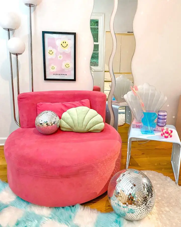 Bright coral velvet ottoman with disco balls and shell pillow from @lady_loves_retro setup.