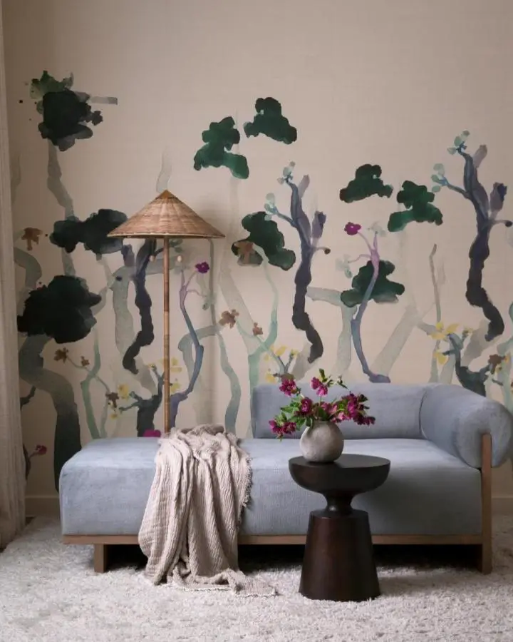 Whimsical hand-painted forest mural from @tribedesigngroup. Features emerald trees and purple branches on pink walls.