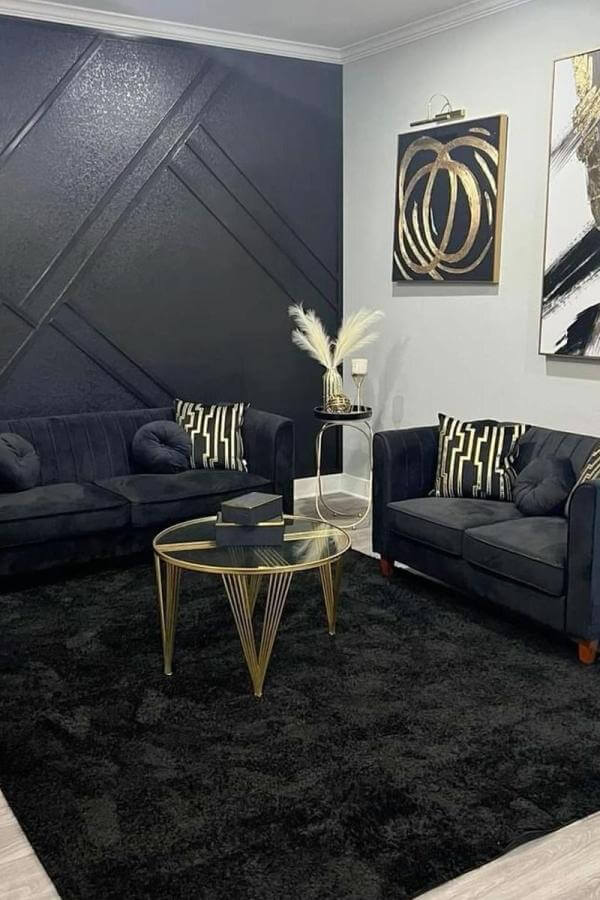 Elegant black & gold living room ideas with chic, illuminated golden accents.