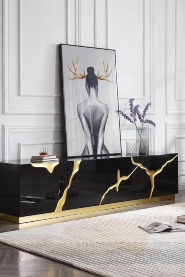 Sculptural statement in black & gold living room ideas displayed elegantly.