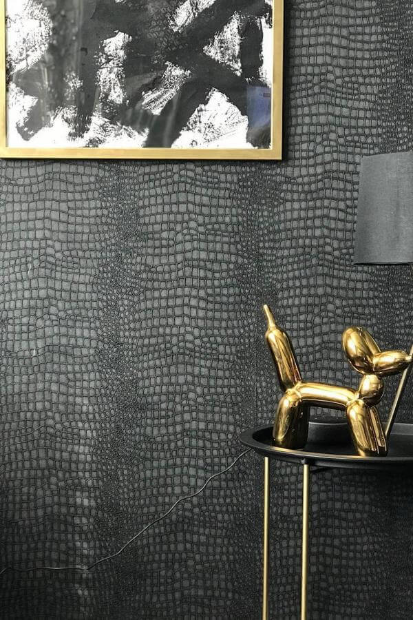 Crocodile texture enhances luxurious black & gold living room ideas.