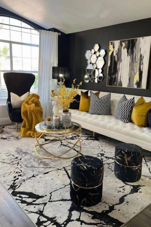 Hexagonal mirrors enhance elegance, complementing black & gold living room ideas.