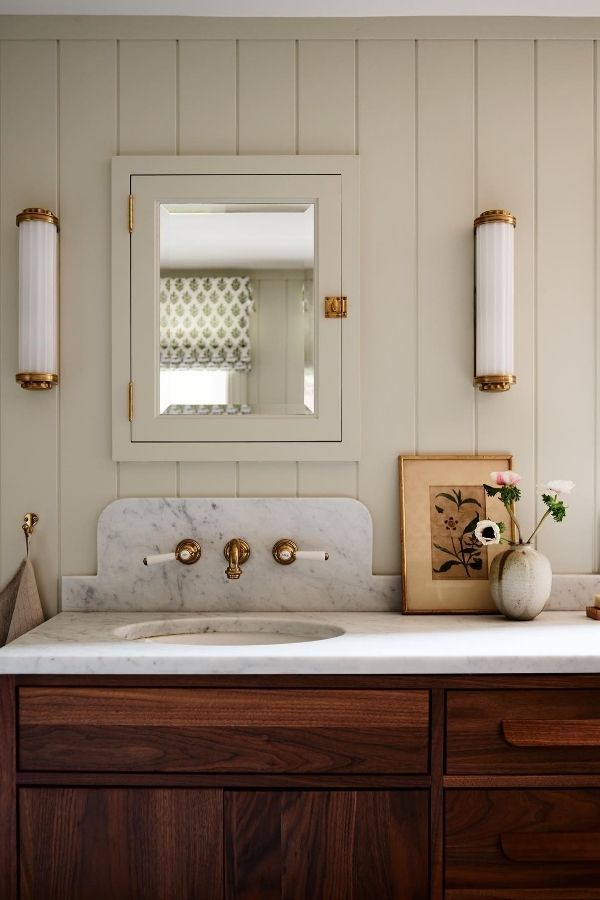 Boho bathroom with rustic wooden cabinetry showcasing creative boho bathroom ideas.