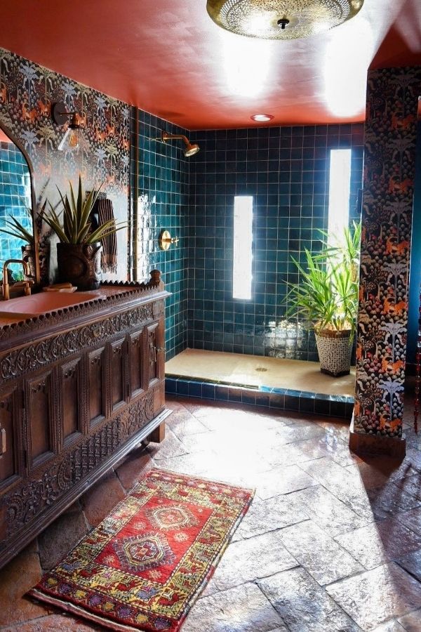 Boho bathroom ideas: Carved wooden vanity enhances eclectic, rustic decor style.