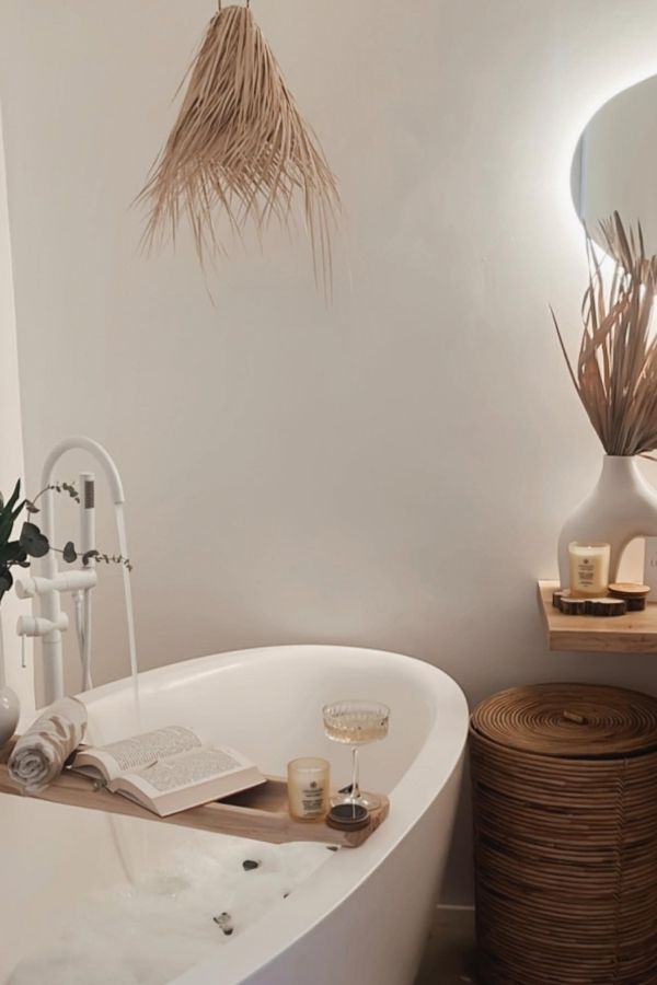 Boho bathroom ideas featuring rattan pendant light; serene oasis design.