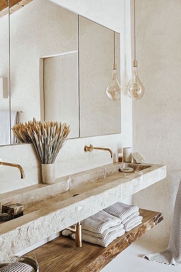 Boho bathroom ideas: Rough-hewn stone sink enhances rustic, eclectic charm.