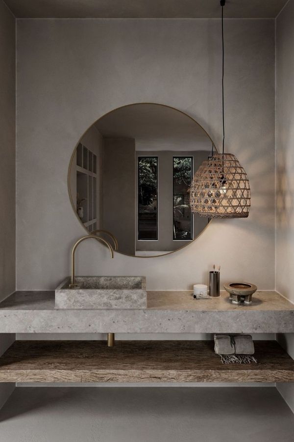 Boho bathroom ideas: Large circular mirror, earthy tones, eclectic decor.