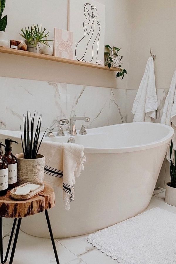 Boho bathroom with charming wooden stool, highlighting boho bathroom ideas.