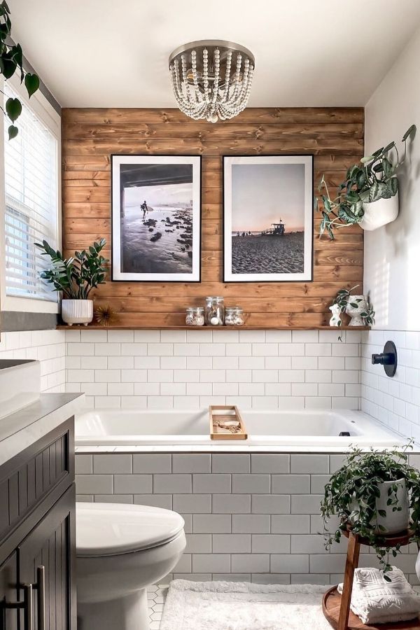 Cozy boho bathroom ideas with a rustic wooden accent wall.