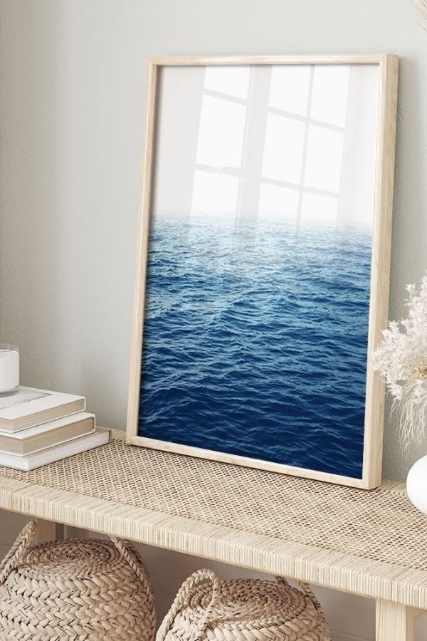 Framed artwork showcasing serene ocean reflection with calming blue hues.