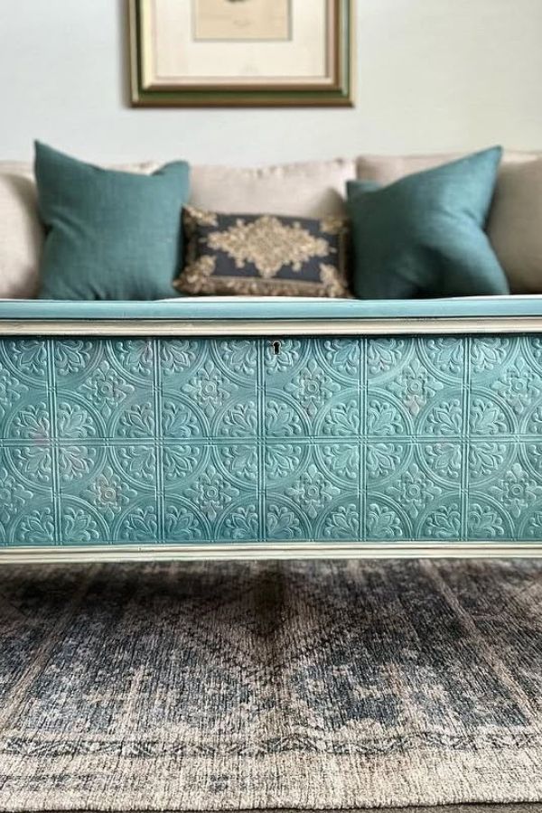 Vintage teal trunk used as a coffee table in living room.