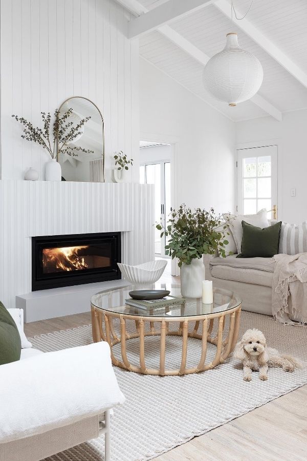 Warm living room with a cozy fireplace and rattan accents.