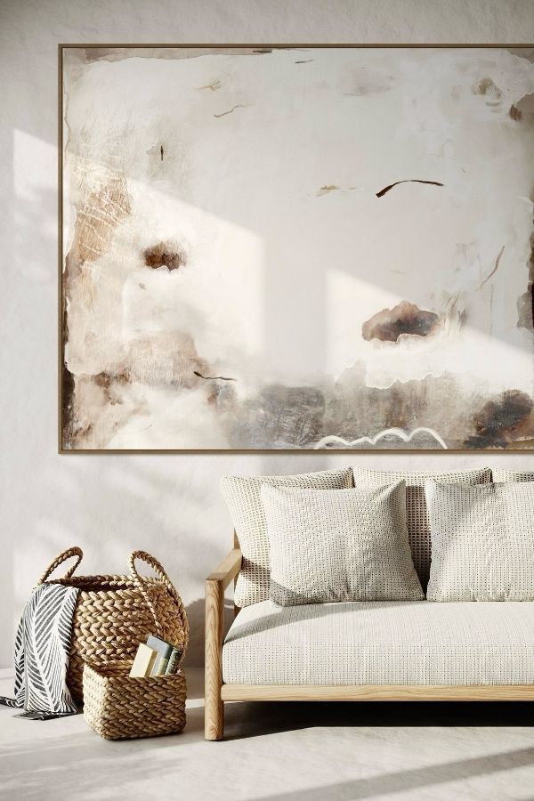 Neutral-toned sofa, textured wall art, cozy, living room, elegant design.