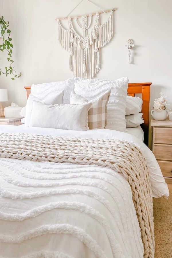 Cozy boho bedroom featuring macrame wall hanging and soft hues.