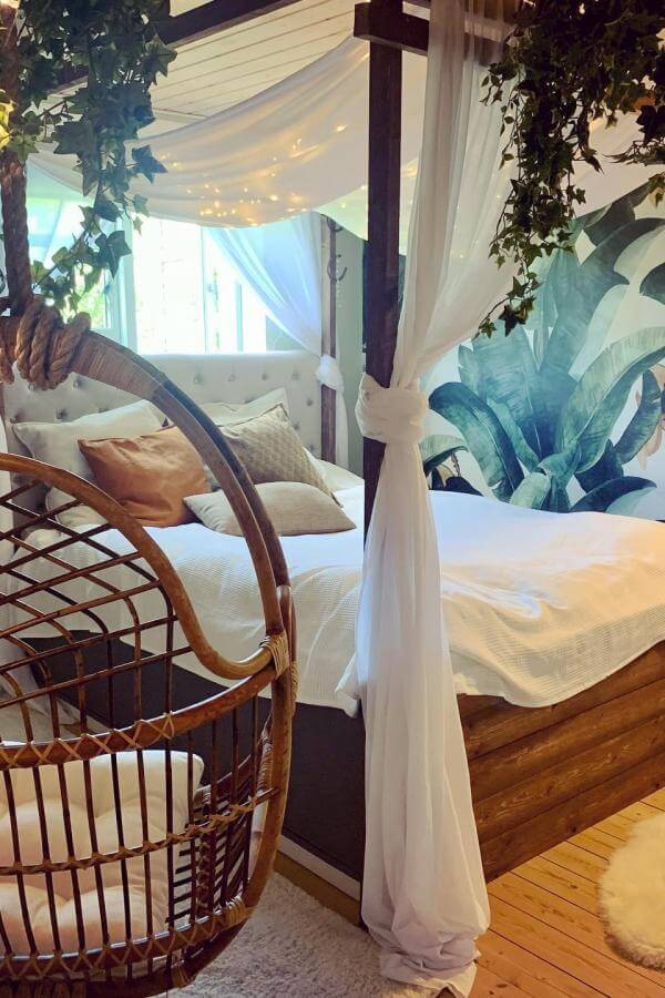 Whimsical cream canopy with a cozy rattan hanging chair from @riefloor; perfect for any boho-inspired space.