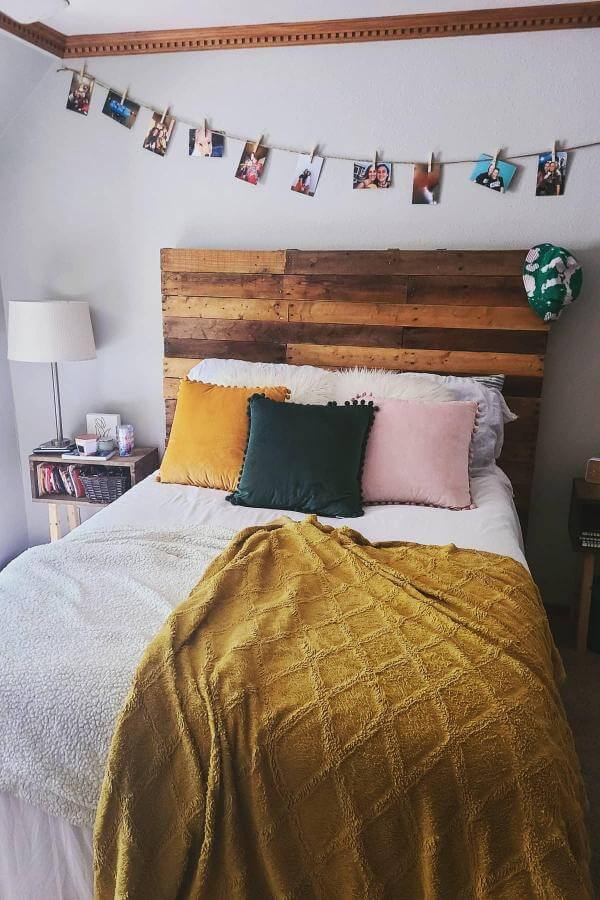 Warm rustic pallet headboard from @thekatieclifton, ideal for a cozy and inviting boho-styled teenage girl's bedroom.