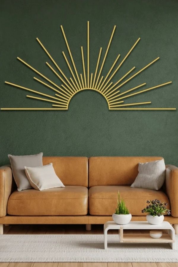 A radiant golden sunburst metal wall decor with reflective details.