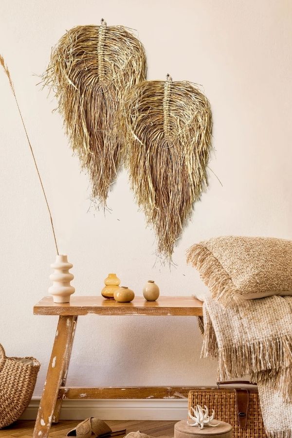 Handcrafted woven grass wall hangings with intricate patterns and textures.