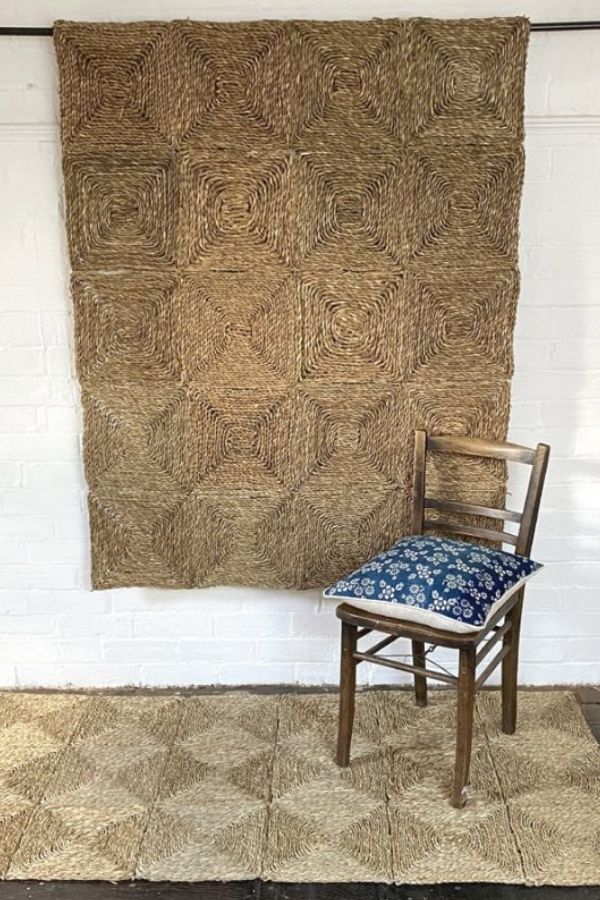 Handcrafted wall hanging with intricate patterns, made from natural fibers.