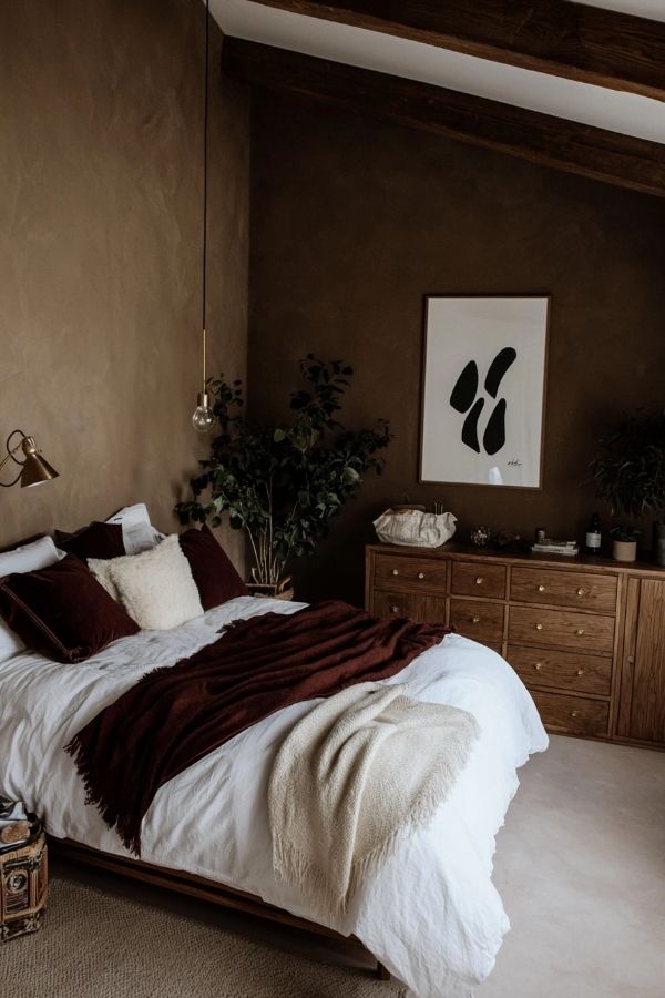 Cozy bedroom featuring wooden furniture, textured rugs, and warm colors.