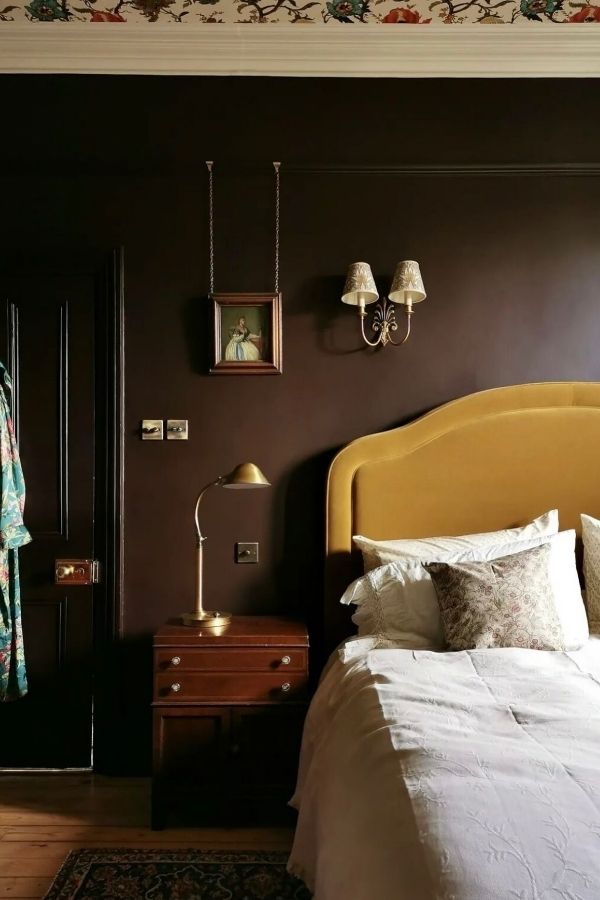 Elegant bedroom with vintage touches, gold accents, and classic decor.