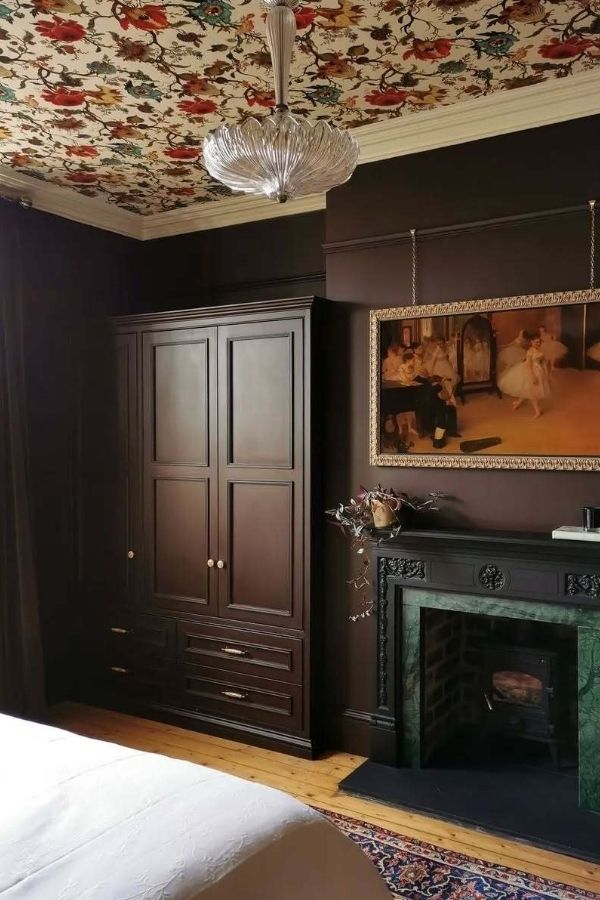 Cozy dark brown bedroom, vibrant colorful ceiling, modern decor, warm ambiance.