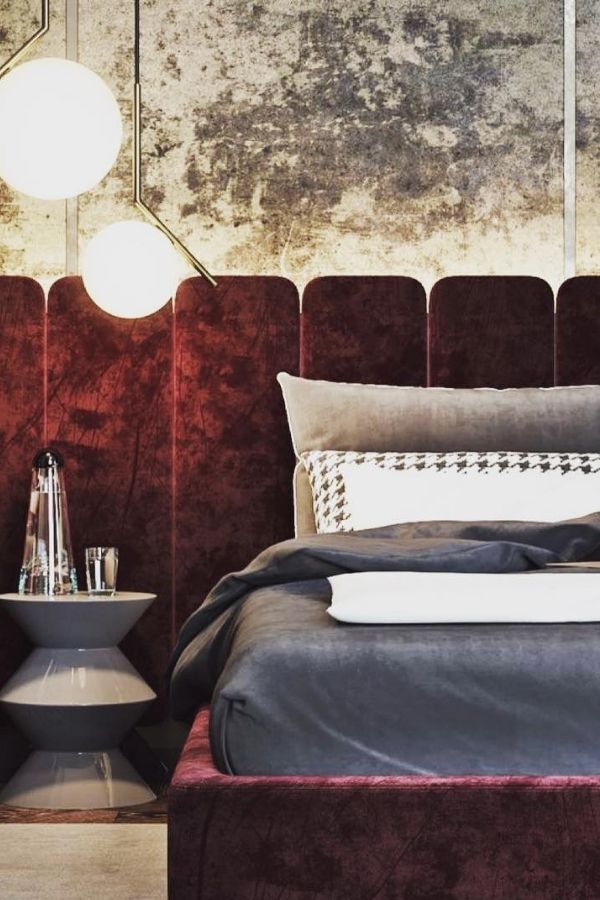 Modern bedroom featuring a burgundy velvet headboard, neutral decor elements.