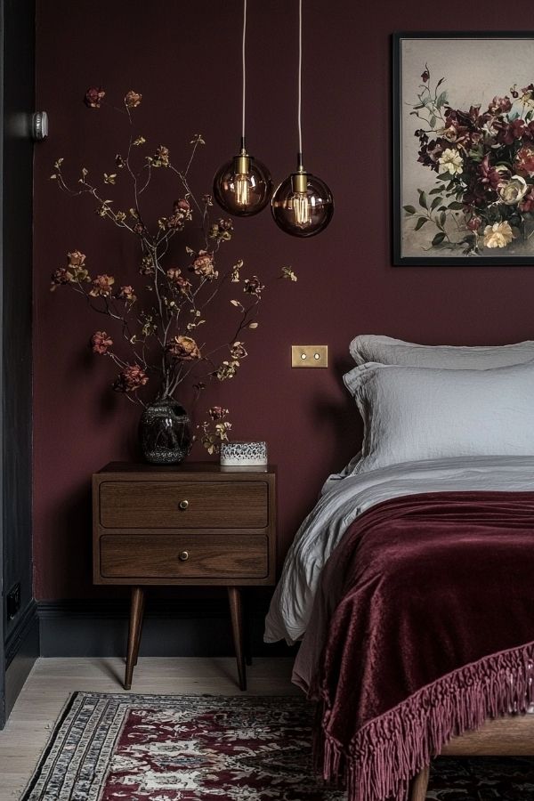 Luxurious bedroom featuring burgundy walls and elegant furnishings, serene ambiance.