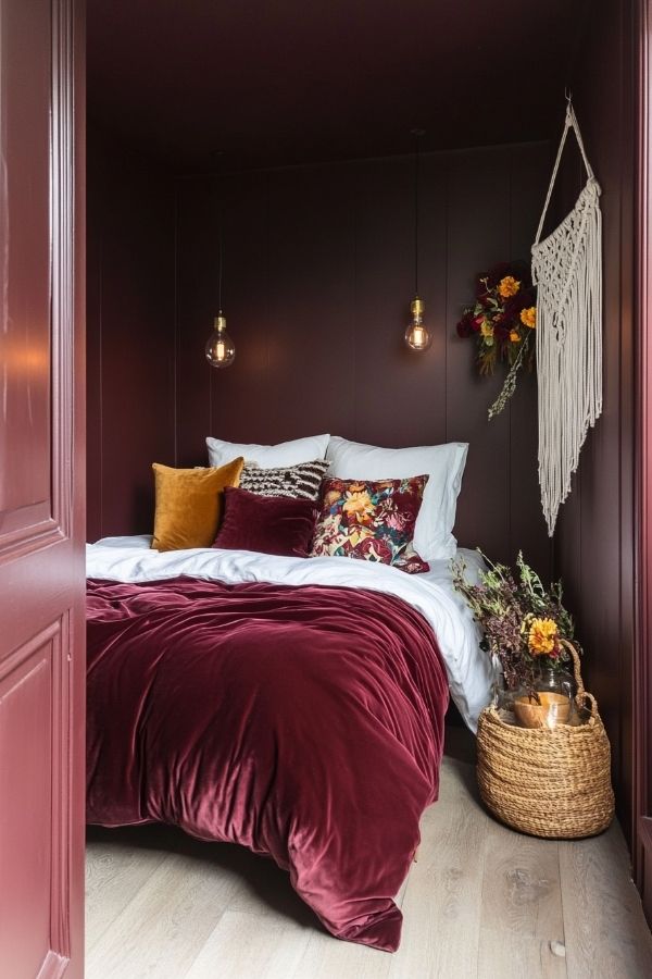 Cozy velvet burgundy bedroom adorned with eclectic boho decor accents.