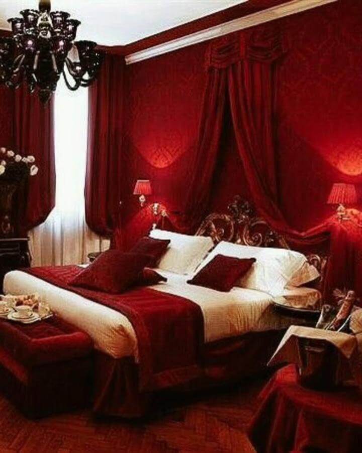 Rich cherry red velvet drapes and textured bedding create a warm, elegant bedroom from @homeinspoideas10 with vintage touches and cozy layers