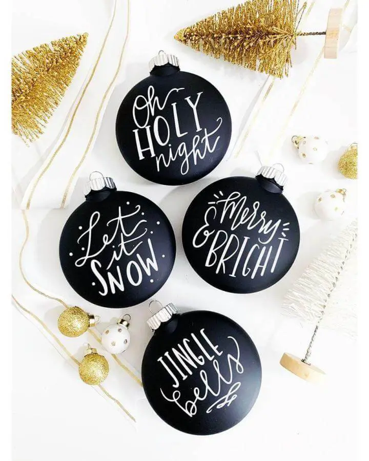 Matte black ornaments with white hand-lettered phrases from @pineapplepapercompany, perfect christmas crafts for adults with modern style.