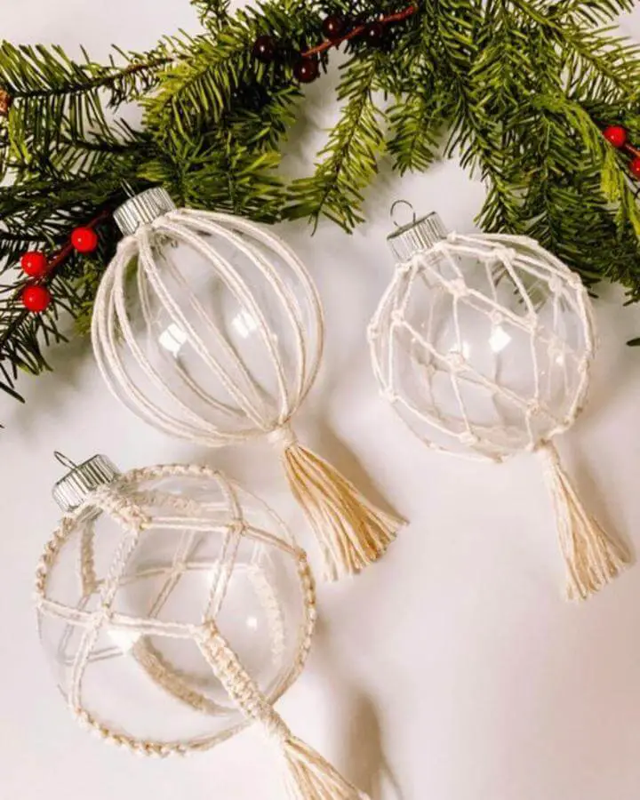 Clear glass ornaments wrapped with cream macramé cord from @hrhlisawhittall, perfect christmas crafts for adults with ivory tassels