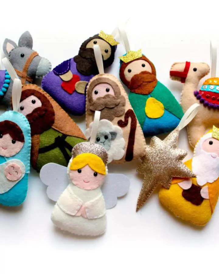 Colorful felt nativity ornaments from PollyChromeCrafts featuring handmade characters with stitched details and glitter accents