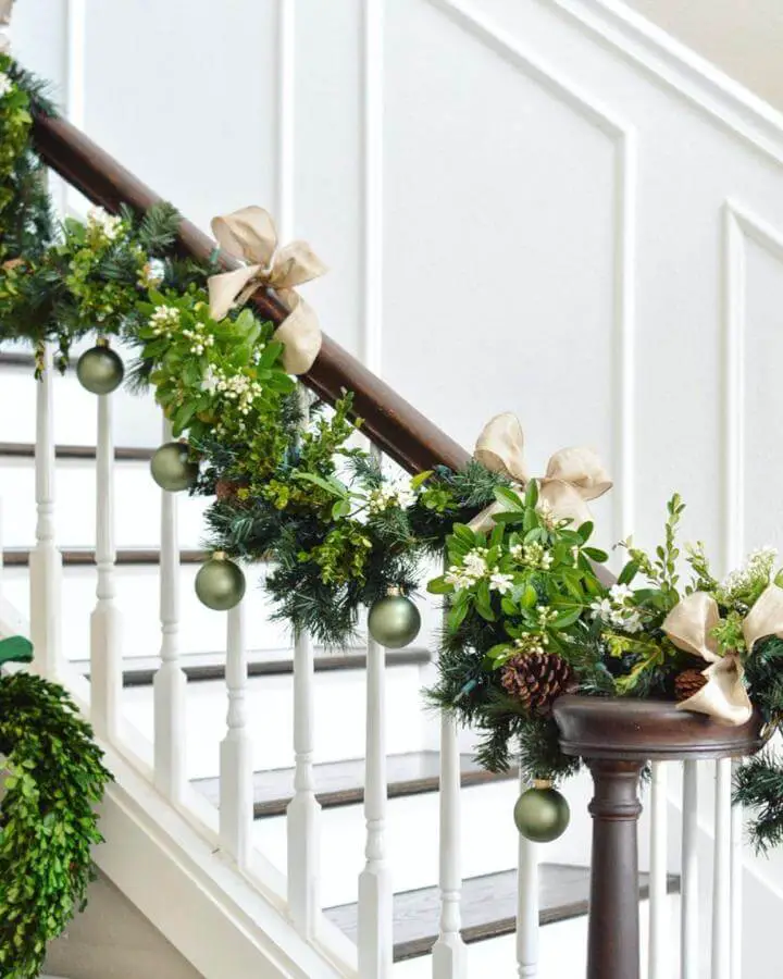 Elegant christmas staircase garland ideas from @centsationalstyle featuring matte olive ornaments and natural boxwood accents.
