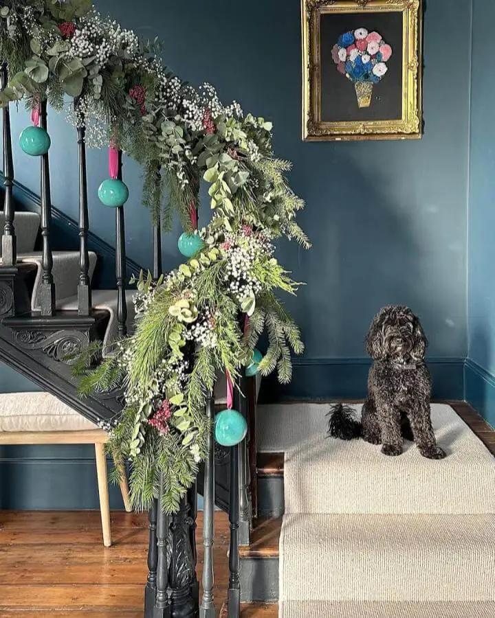 Turquoise ornament christmas staircase garland ideas from @geekvintique with eucalyptus and white berries on dark banister