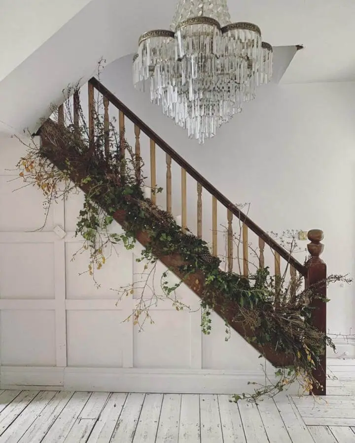 Rustic foliage and ivy garland on wooden staircase from @hannahbeaumontlaurencia with cascading greenery and branches