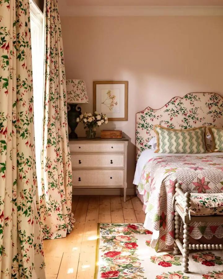 Floral upholstered headboard from @mainehouseinteriors. Matching wallpaper and curtains create coordinated cottage style.