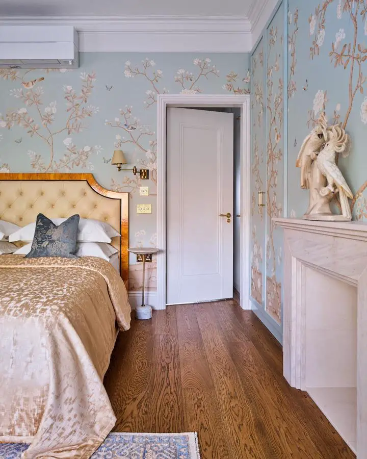 Powder blue botanical wallpaper bedroom from @krikla_interior. Features tufted cream headboard and decorative horse sculpture.
