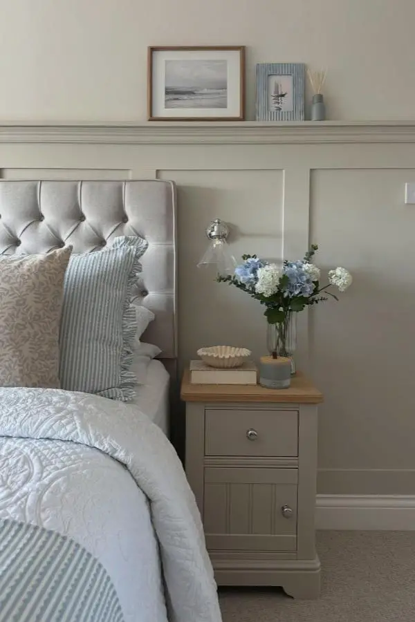 Sage green paneled bedroom from @our_home_on_thehill. Striped blue linens and seaside artwork complete the look.