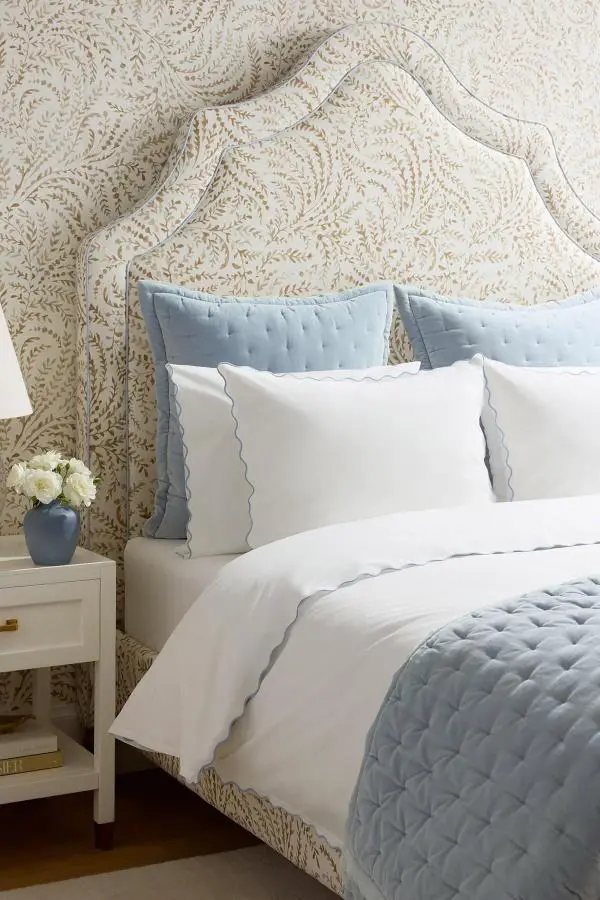Botanical wallpaper bedroom from @serenaandlily. Cream and blue bedding with scalloped upholstered headboard design.