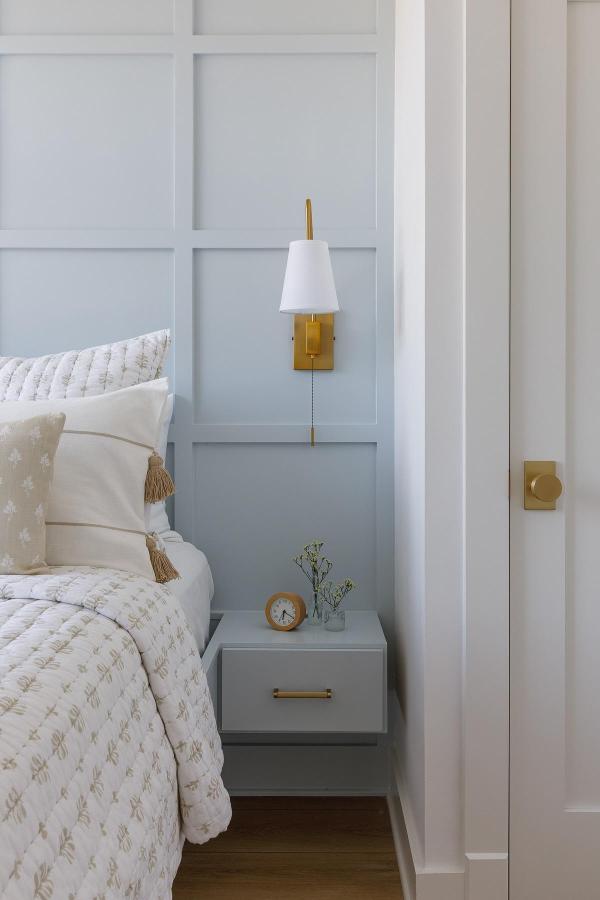 Soft blue board and batten bedroom from @lolainteriors. Perfect coastal bedroom ideas inspiration with built-in nightstand.