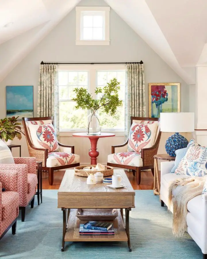 Coral damask accent chairs from @donnaelledesign showing coastal living room ideas with bold patterns.