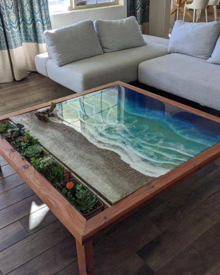 Resin ocean coffee table from @kara.ivey.art. Turquoise waves with wood frame and glass top.