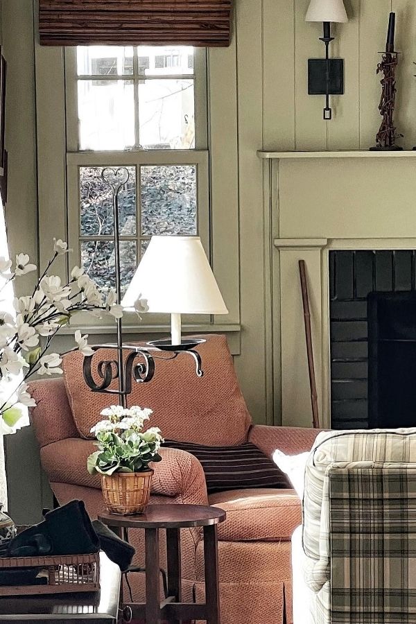 Warm colonial living room with a cozy fireplace and armchairs.