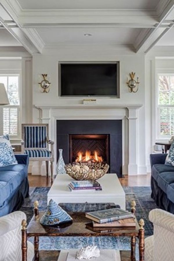 Vintage colonial room with blue walls, wooden furniture, and decor.