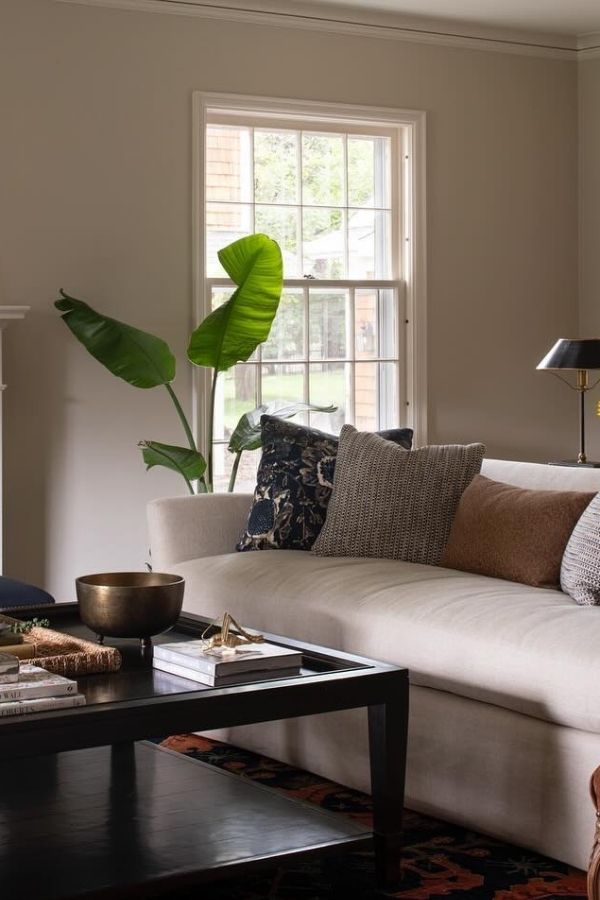 Cozy colonial living room with sunflowers, warm lighting, and fireplace.