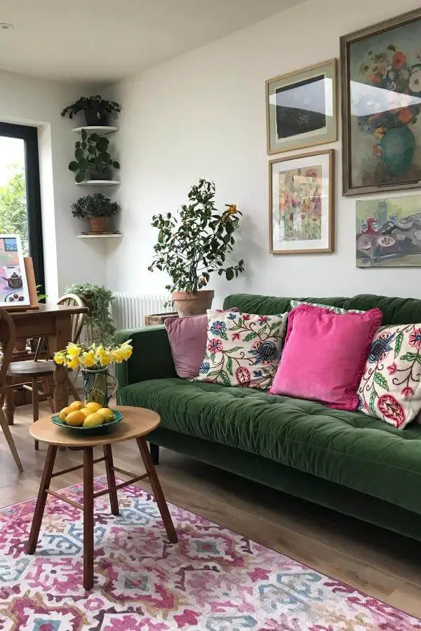 plush velvet green sofa from @fionacumberpatch. Bold centerpiece enhancing cozy cottage charm.