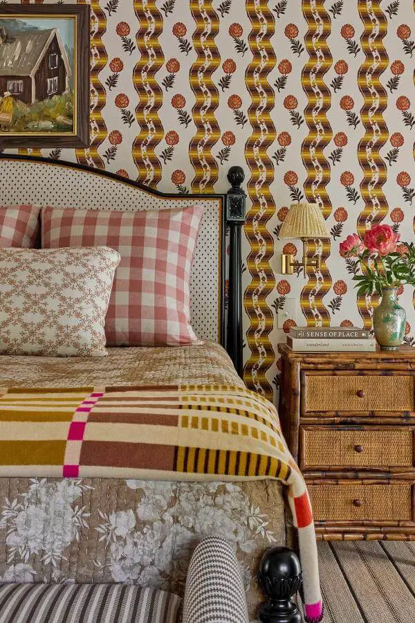 Whimsical floral wallpaper sets a charming vintage scene in a cozy room from @katierosenfeld, blending colorful cottagecore interior.
