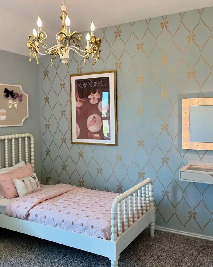 Sage green bedroom with gold geometric wallpaper from @joyscribbles. Pink bedding and white spindle bed complete the feminine look.